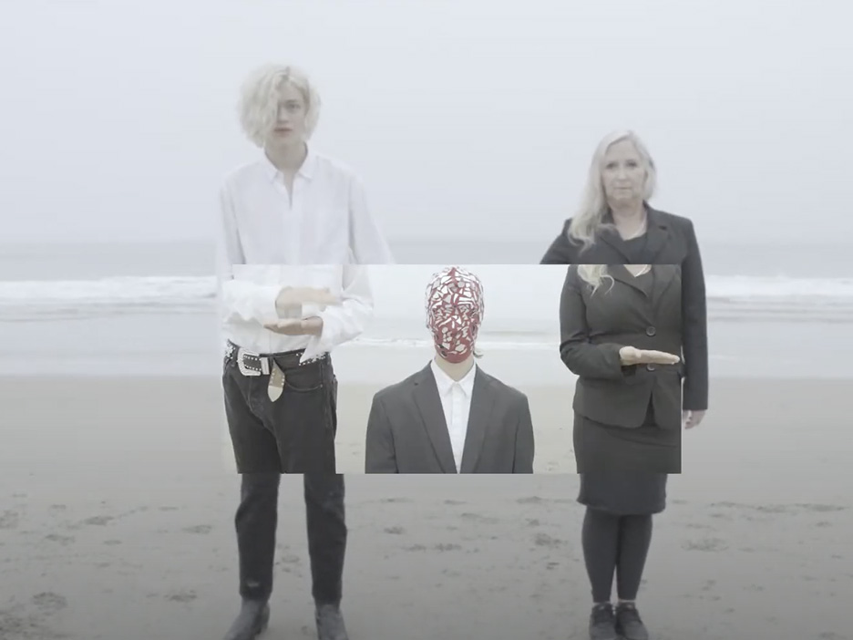 Still frame from the music video Beacon showing two people standing at the beach.