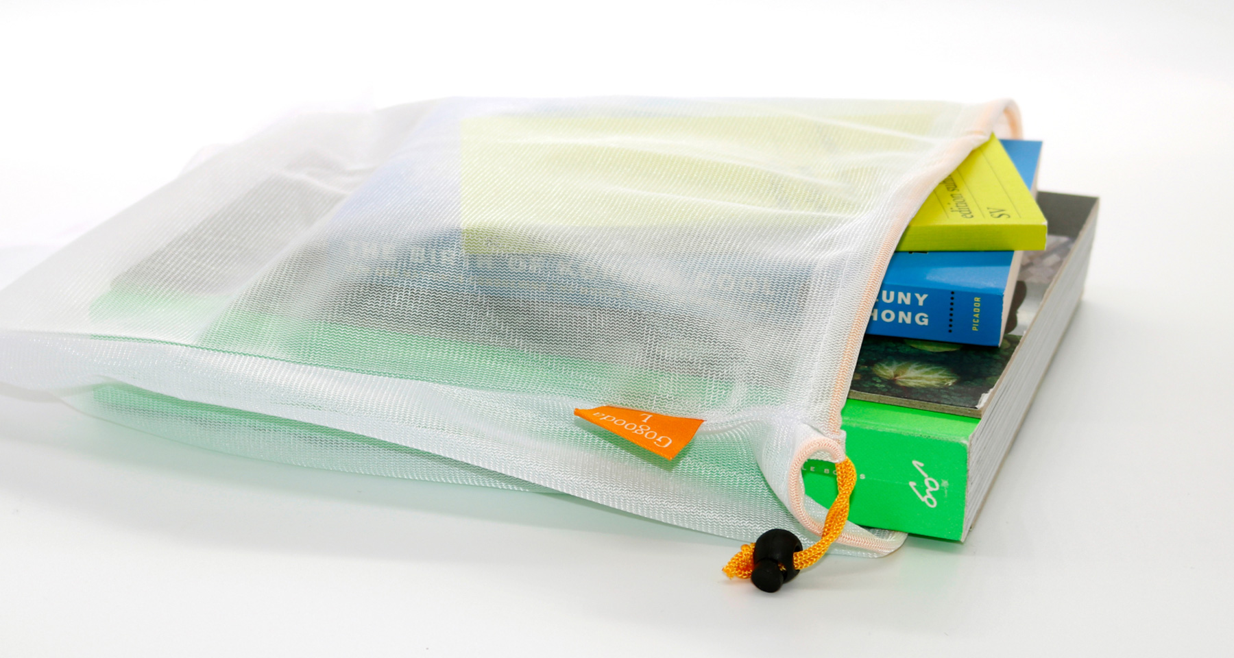 A mesh fabric bag filled with books.