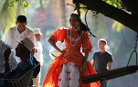 Thumbnail image of a woman in a red Mexican dress dancing.