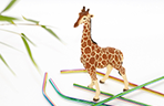 Thumbnail image of a toy giraffe standing among reusable straws.
